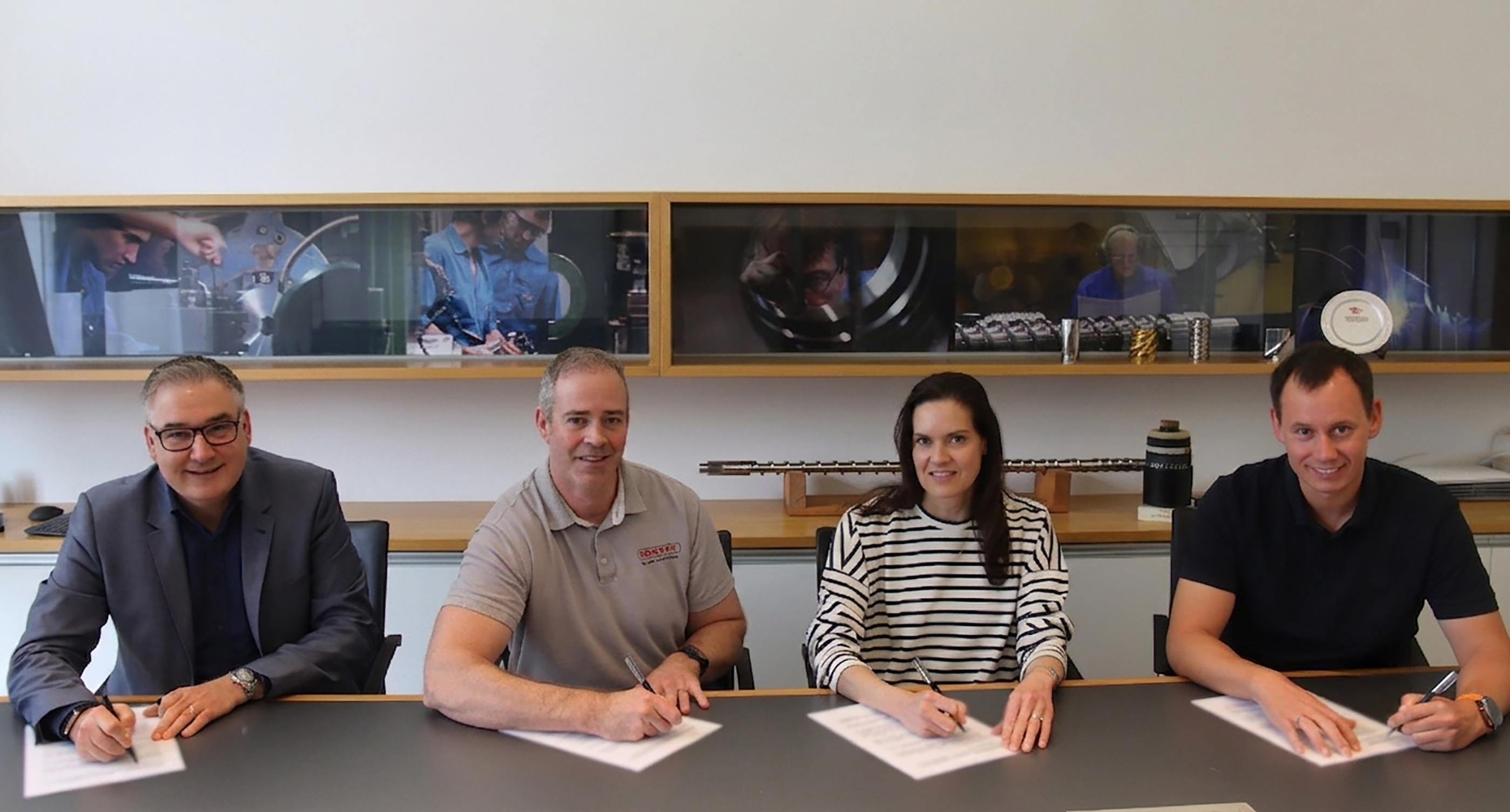 Sealing the Partnership: Thomas Holzer, Zach Boaz, Rachel Boaz and Stephan Bartelt officially signed the historic partnership agreement.
